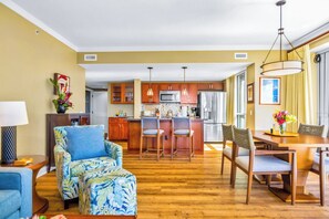 A modern kitchen with wooden cabinets, a central island, and pendant lighting. - Honua Kai | Ocean View 7 BR, Sleeps 20 | Car Incl. w/ 6+ Nights | HKK ML-3416 by KBM (Lahaina)