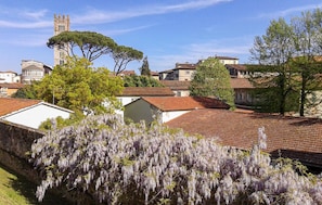 A residential area with traditional architecture, including a tower and a church, surrounded by trees and houses with red-tiled roofs. - 2 bedroom awesome home in Gioviano (Gioviano)