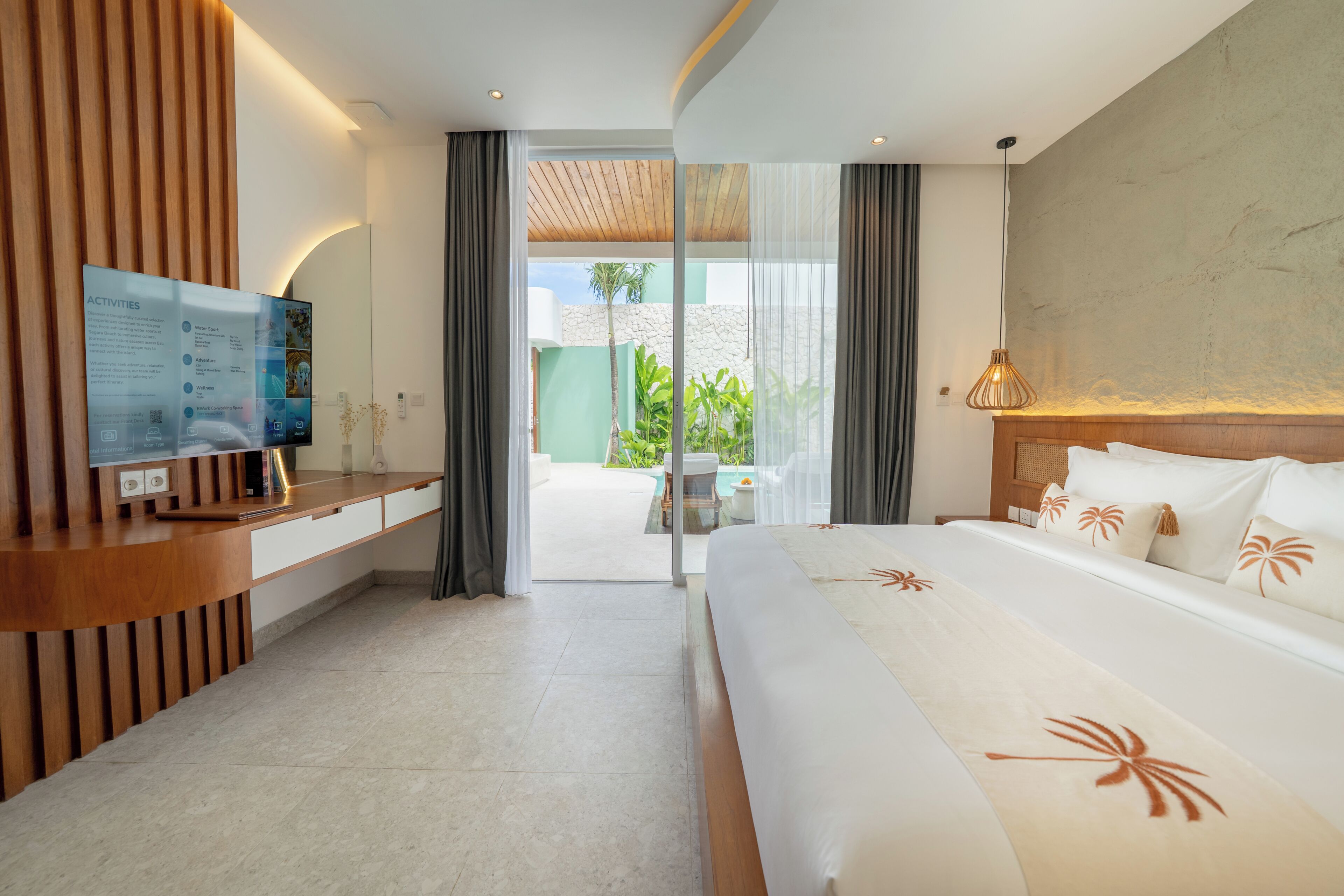 A modern hotel room with a large bed, a desk with a flat-screen TV, a wooden panel wall, and a view of the outdoors.