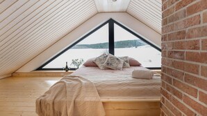 A cozy attic bedroom with a bed, pillows, and a blanket. - Stunning home in Dmuchowo with WiFi (Dmuchowo)
