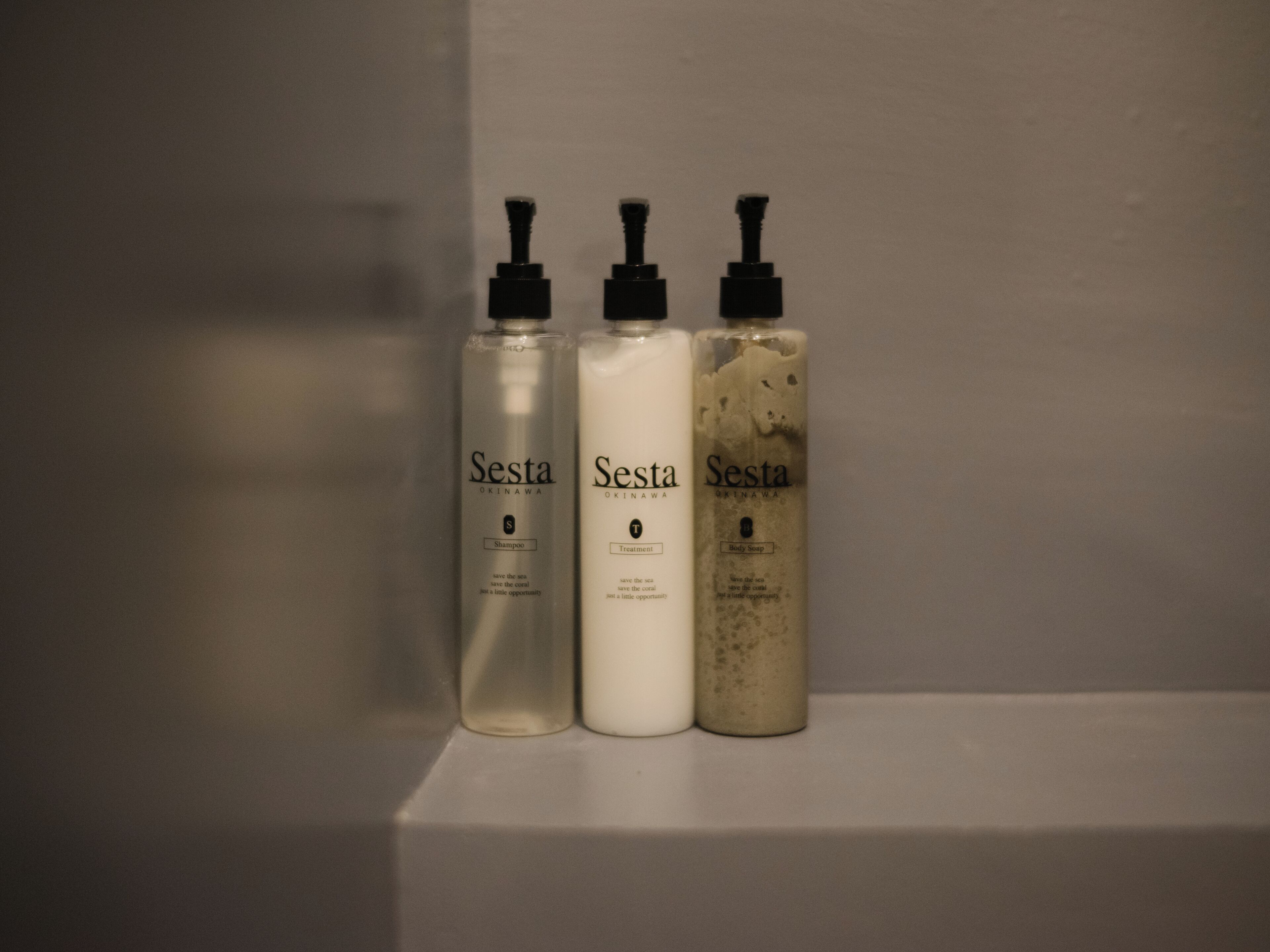 Three Sesta Okinawa bottles on a shelf.