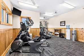 A gym with treadmills, elliptical machines, and weight equipment.