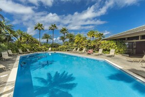 A swimming pool with lounge chairs and palm trees. - Kapalua Ridge | Ocean View 5 BR, Sleeps 14 | Car Incl. w/ 6+ Nights | KRV ML-3948 by KBM (Lahaina)