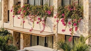 A modern building with stone walls, large windows, and a wooden roof. - La Brava  (Pecatu)