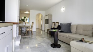 Una sala de estar moderna con un sofá, una mesa de centro y un televisor.