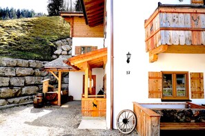 A rustic wooden building with a stone wall and a wooden porch. - xxxChalet Kogelleiten, for 4 people (Ramsau bei Berchtesgaden)