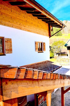 A wooden house with a sloped roof and a wooden deck. - xxxChalet Kogelleiten, for 4 people (Ramsau bei Berchtesgaden)