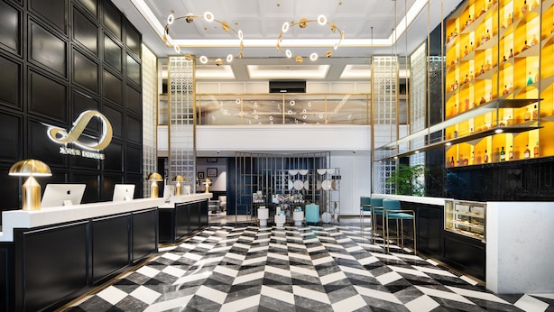 A hotel lobby with a check-in counter, seating area, and a bar. - XANA Deluxe International Hotel Guangzhou East Railway Station Branch - Free Shuttle Bus to Canton Fair Complex During Canton Fair Period (Guangzhou)