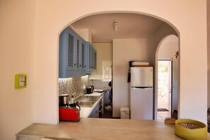 A kitchen with a red toaster, a sink, and blue cabinets. - Casa Pabas - Altea, Costa Blanca (Altea)