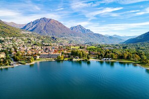 A lakeside town with a prominent mountain in the background.