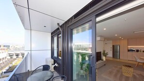 Un apartamento moderno con balcón, cocina y comedor.