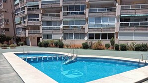A rectangular swimming pool with a tiled border, surrounded by a concrete deck. - Frontline Beach Penthouse ApoloXI Calpe (Calpe)