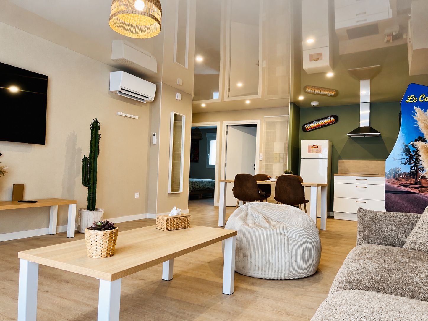 A modern living room with a sofa, bean bag, and a dining table.