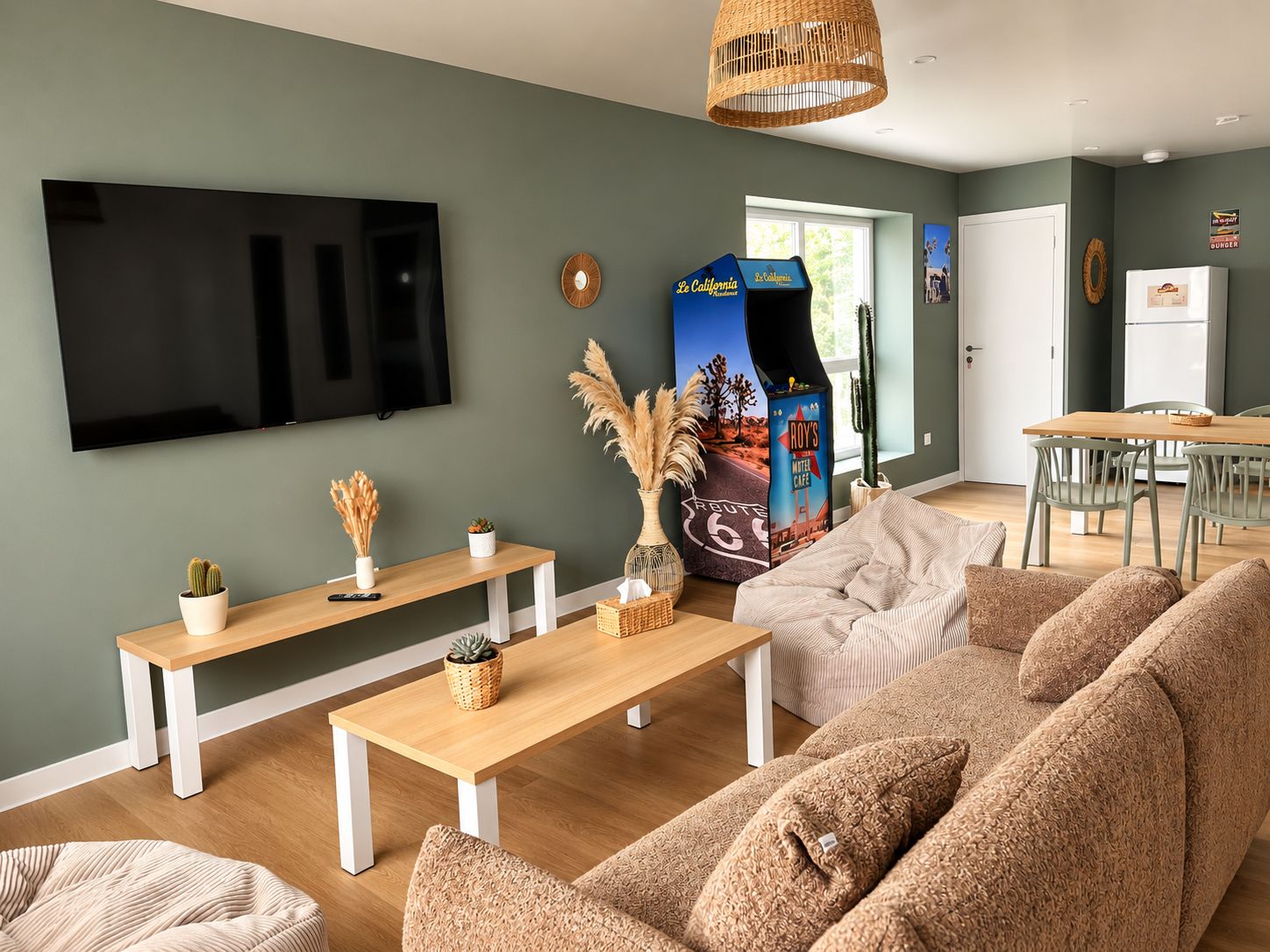 Un salon moderne doté d’un téléviseur à écran plat, de meubles en bois et d’une décoration murale sur le thème de la Route 66.
