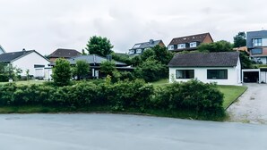 A residential area with houses, a driveway, and a grassy area.