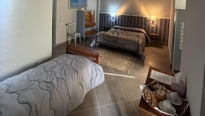 Ein Schlafzimmer mit Bett, Stuhl, Schreibtisch und Nachttisch.
