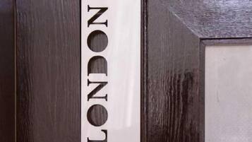 A door with a sign that reads 'LONDON' and a red tree logo.