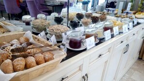A buffet with various food items and containers. - Optima Collection Chernihiv (Chernihiv)