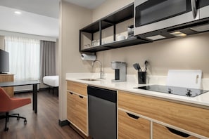 A modern kitchen with a dishwasher, coffee maker, and a microwave. - LivSmart Studios by Hilton Columbia Greystone (Columbia)