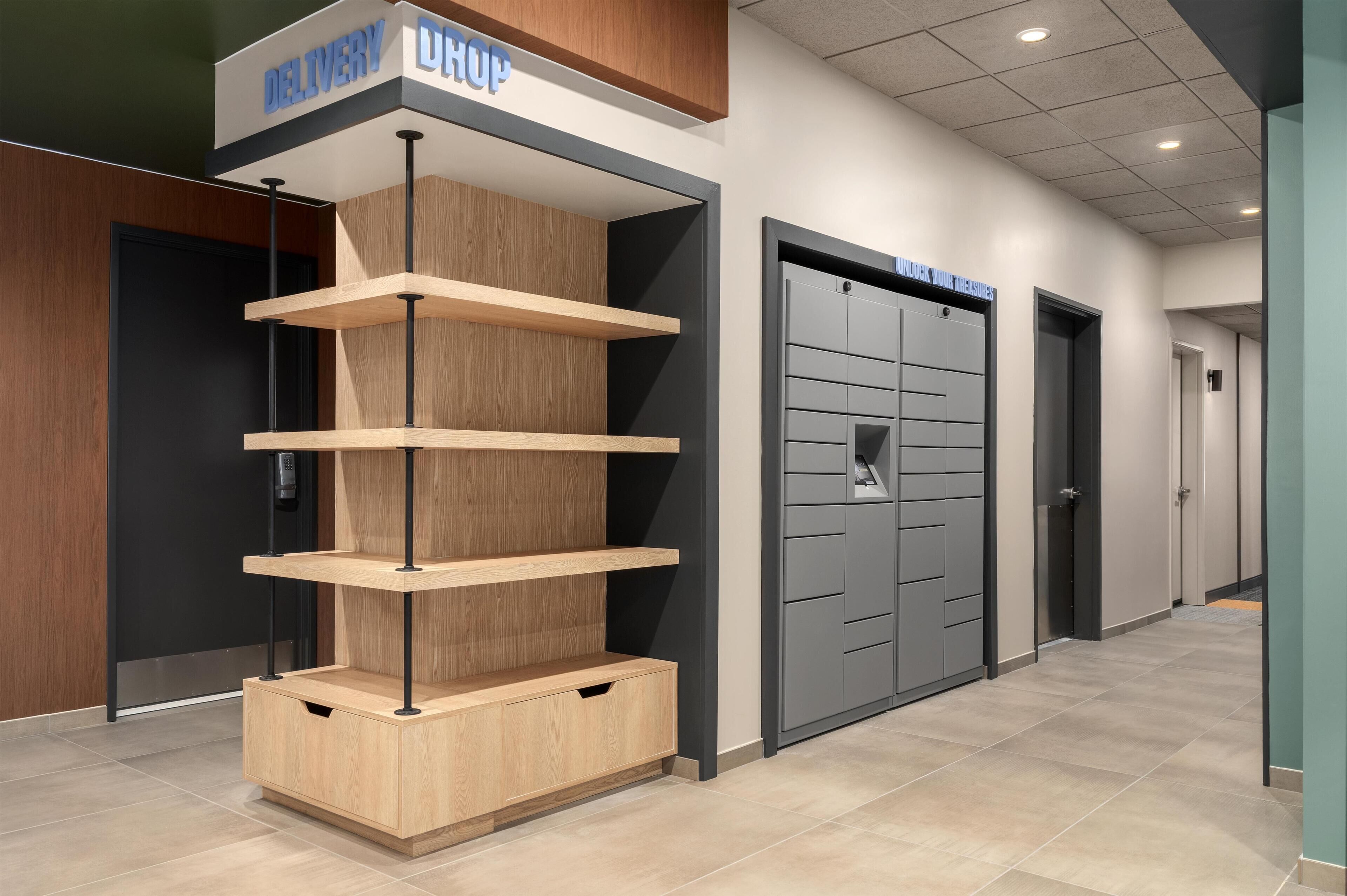 A modern interior with a wooden display unit and a grey storage door labeled 'Unlock Your Treasures'.