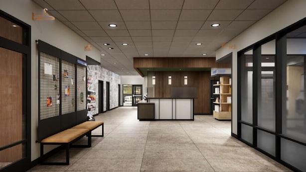 Un interno moderno con una reception, una panca e un muro con una bacheca.
