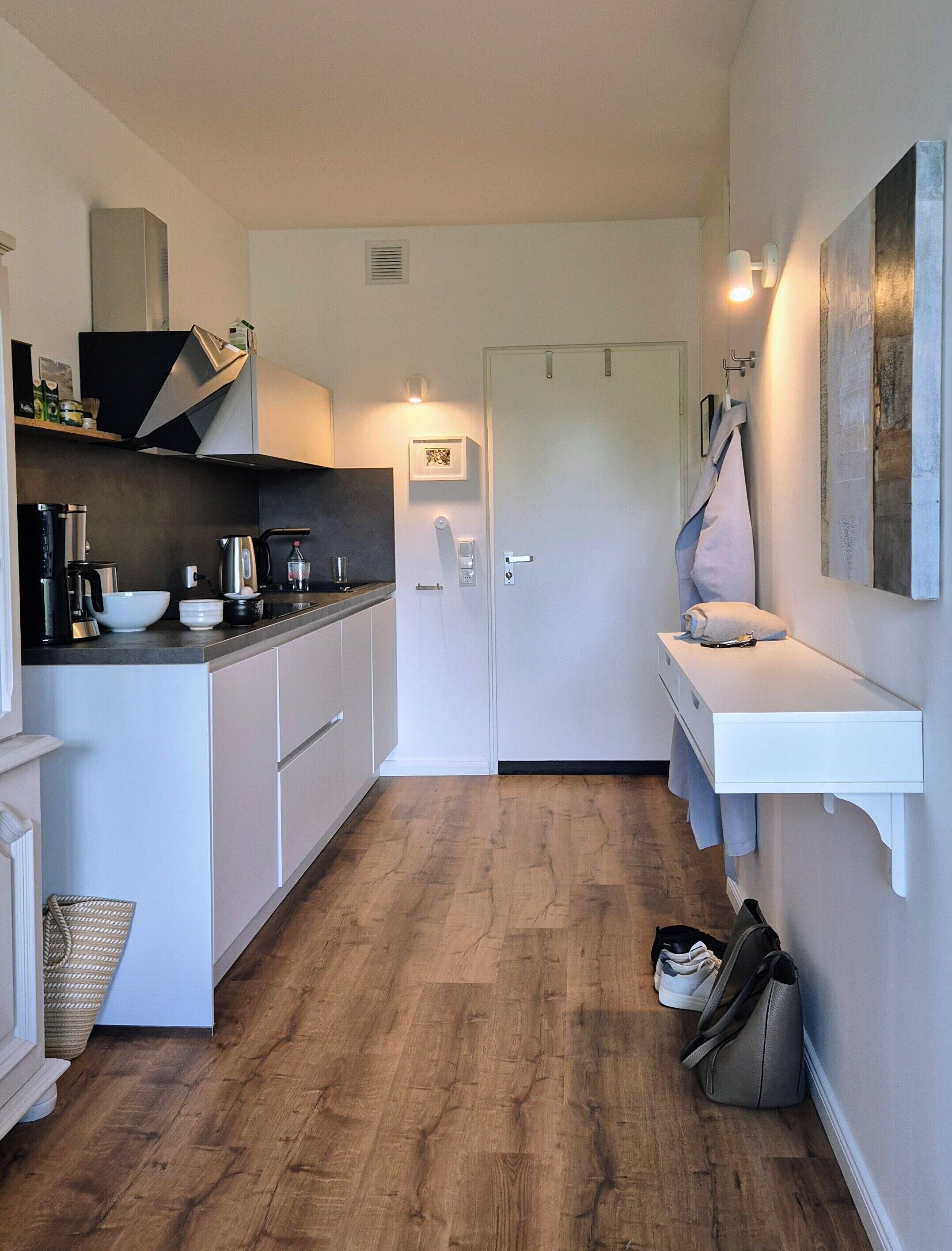 Fridge, stovetop, dishwasher, coffee/tea maker