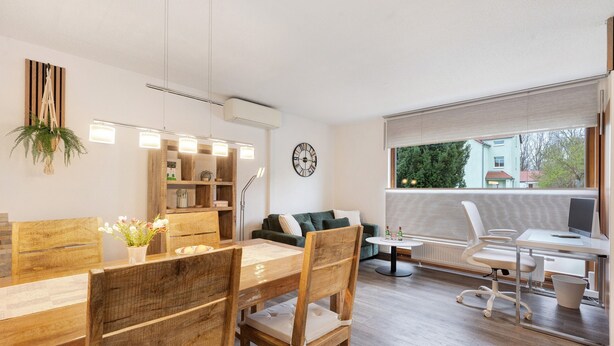 A modern living room with a dining area, a sofa, a coffee table, and a desk with a chair. - Apartment “Linie 8” with Wi-Fi (Dresden)