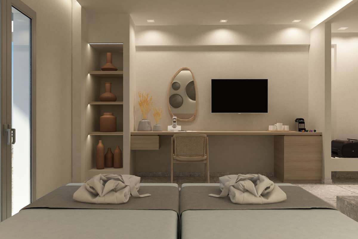A modern hotel room with a bed, a desk, a chair, a TV, and a shelf with decorative items.