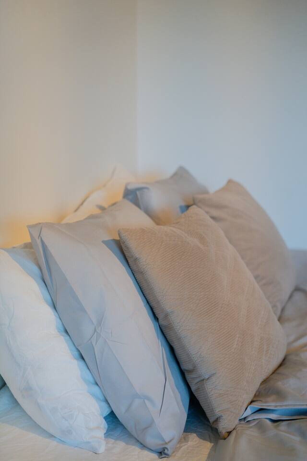 A bed with pillows and a blanket.