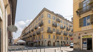 En byggnad med flera våningar, balkonger, ett café vid gatan och en skylt för Western Union.