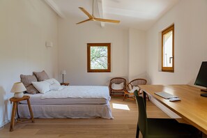 A bedroom with a bed, a desk, a chair, a ceiling fan, and a window. - Beautiful house on the edge of the charming village of Pigna (Pigna)