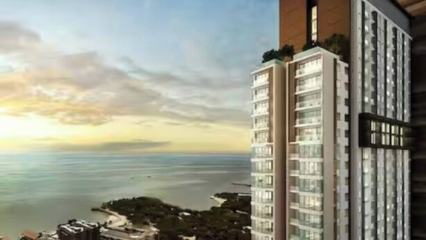 A high-rise building with multiple floors, large windows, and a view of the sea. - Pattaya Studio Walk to Beach Walking Street (Pattaya)