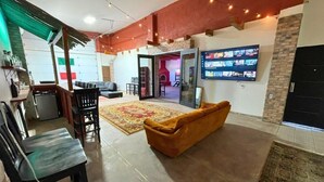 A spacious living area with a sofa, chairs, a TV, and a fireplace. - The Big House Baja - 5BR Vacation Rental with Private Pool (San Felipe)