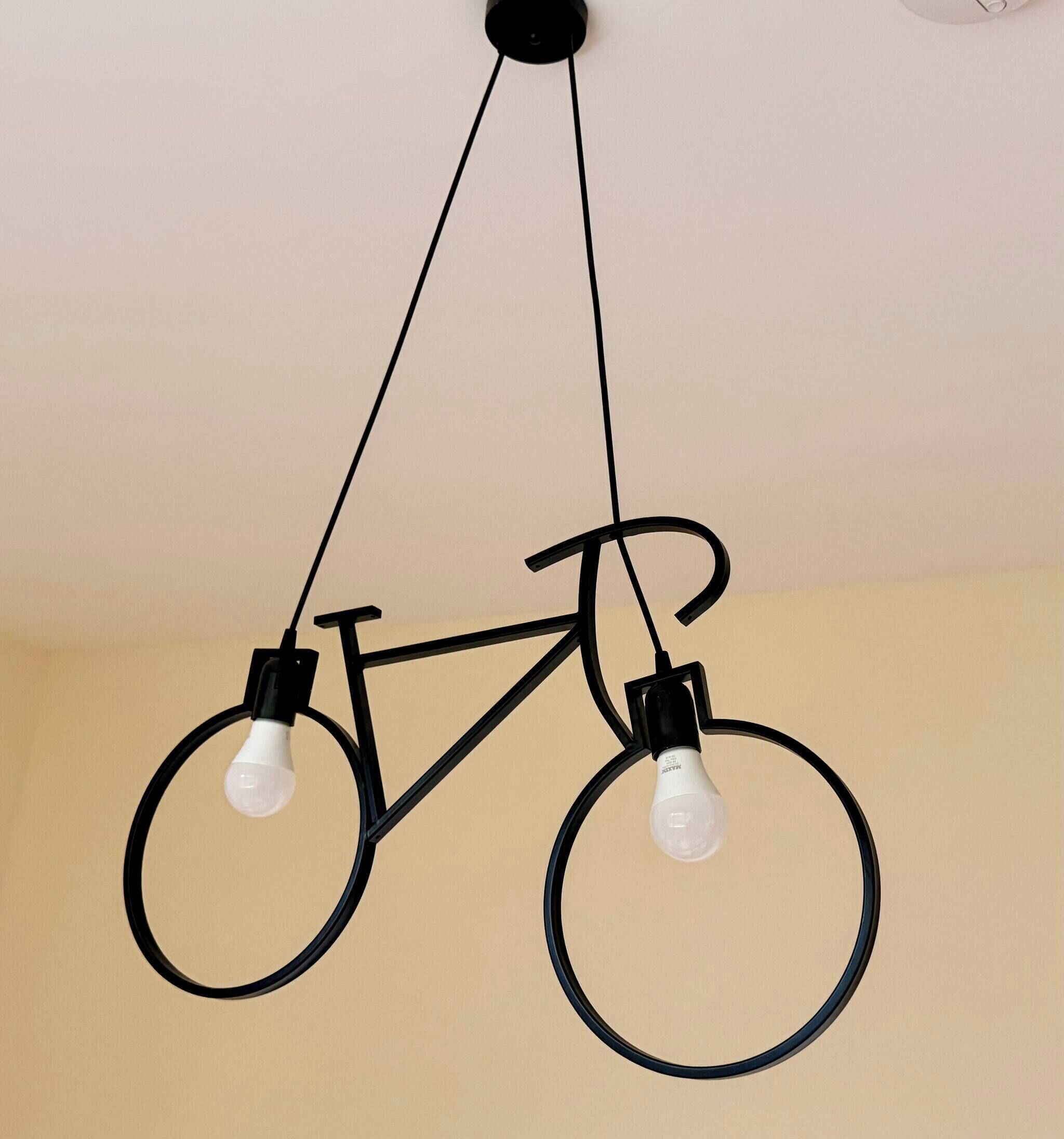 A bicycle-shaped light fixture with two bulbs hanging from the handlebars.