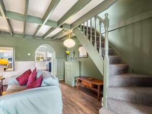 A room with a staircase, a bed with pillows, a desk, and a lamp. - Bun Inbhir cottage with views (Rosmuck)