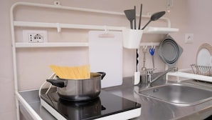 A kitchen with a stove, pots, and utensils. - LA CASA DEL VINO-THE WINE HOUSE (Parma)