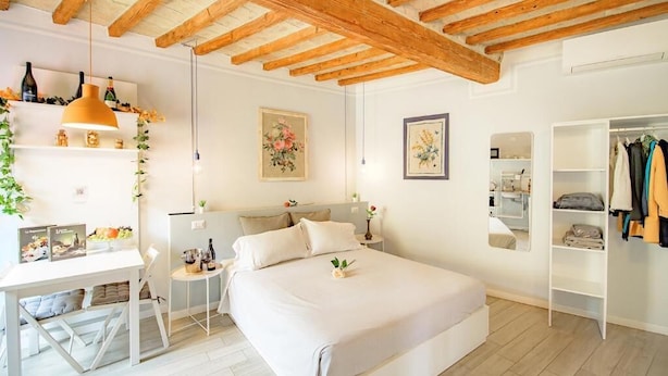A bedroom with a bed, bedside tables, a wardrobe, and a desk with a chair. - LA CASA DEL VINO-THE WINE HOUSE (Parma)