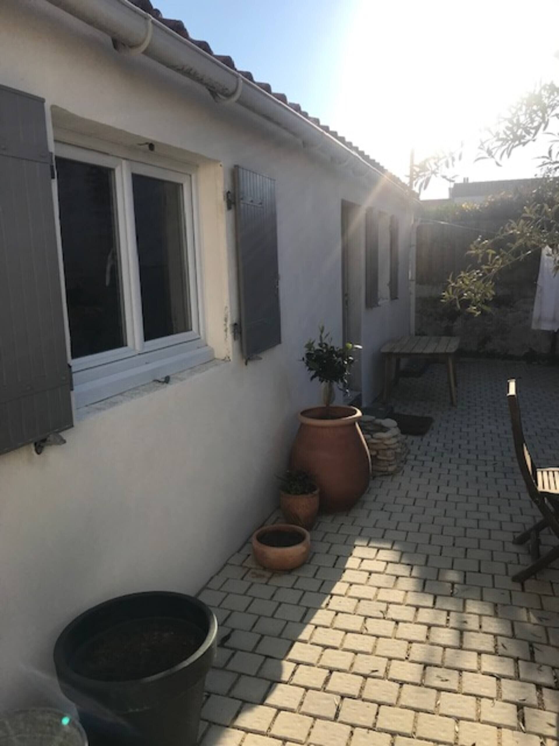 A house with a window, a door, and a brick patio.