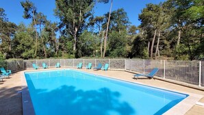 A rectangular swimming pool with a tiled deck, surrounded by a metal fence. - The Geraniums Apartment - ref 305 (La Tranche-sur-Mer)