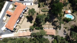 An aerial view of a residential area with a large building with a red roof, a swimming pool, and surrounding greenery. - The Geraniums Apartment - ref 305 (La Tranche-sur-Mer)