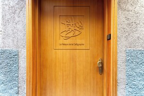 A wooden door with a carved emblem and the text 'La Maison de la Calligraphie.' - Riad House of Calligraphy Marrakech (Marrakech)