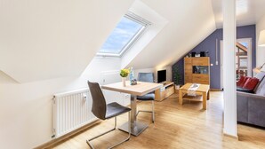 A modern loft apartment with a skylight, a dining area, and a living space. - Holiday Apartment for 2 People (45 m²) in Bad Arolsen (Bad Arolsen)