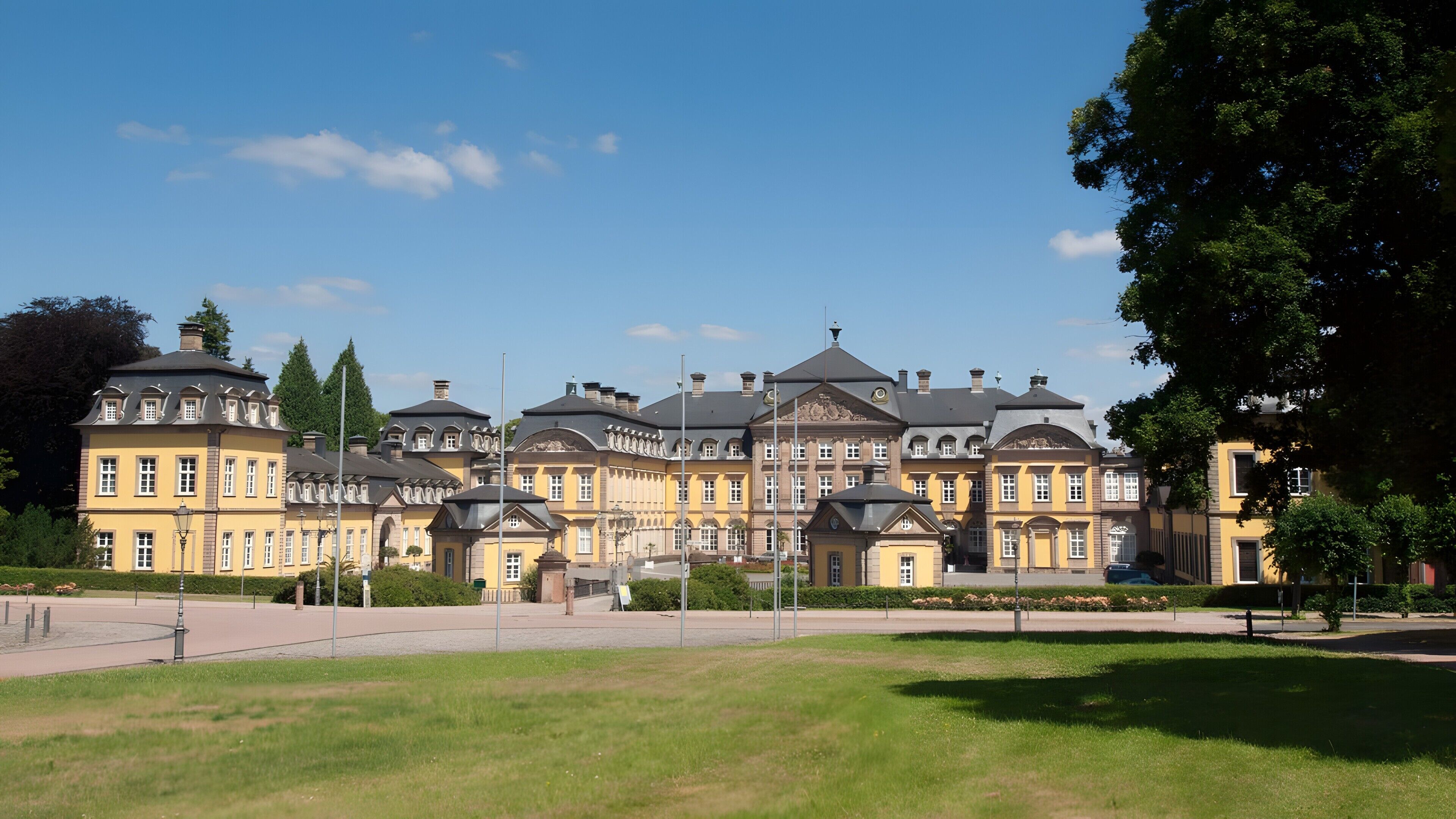 A large, historic building with multiple wings and a central courtyard.