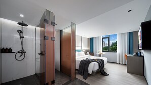 A modern hotel room with a shower, bed, desk, and a view of the outdoors. - PIN Hotel Guangzhou Beijing Road Pedestrian Street Gongyuanqian Metro Station Branch - Free Deliver Service to Guangzhou Baiyun International Airport & Free Deliver Service to Canton Fair Complex During Canton Fair Period (Guangzhou)