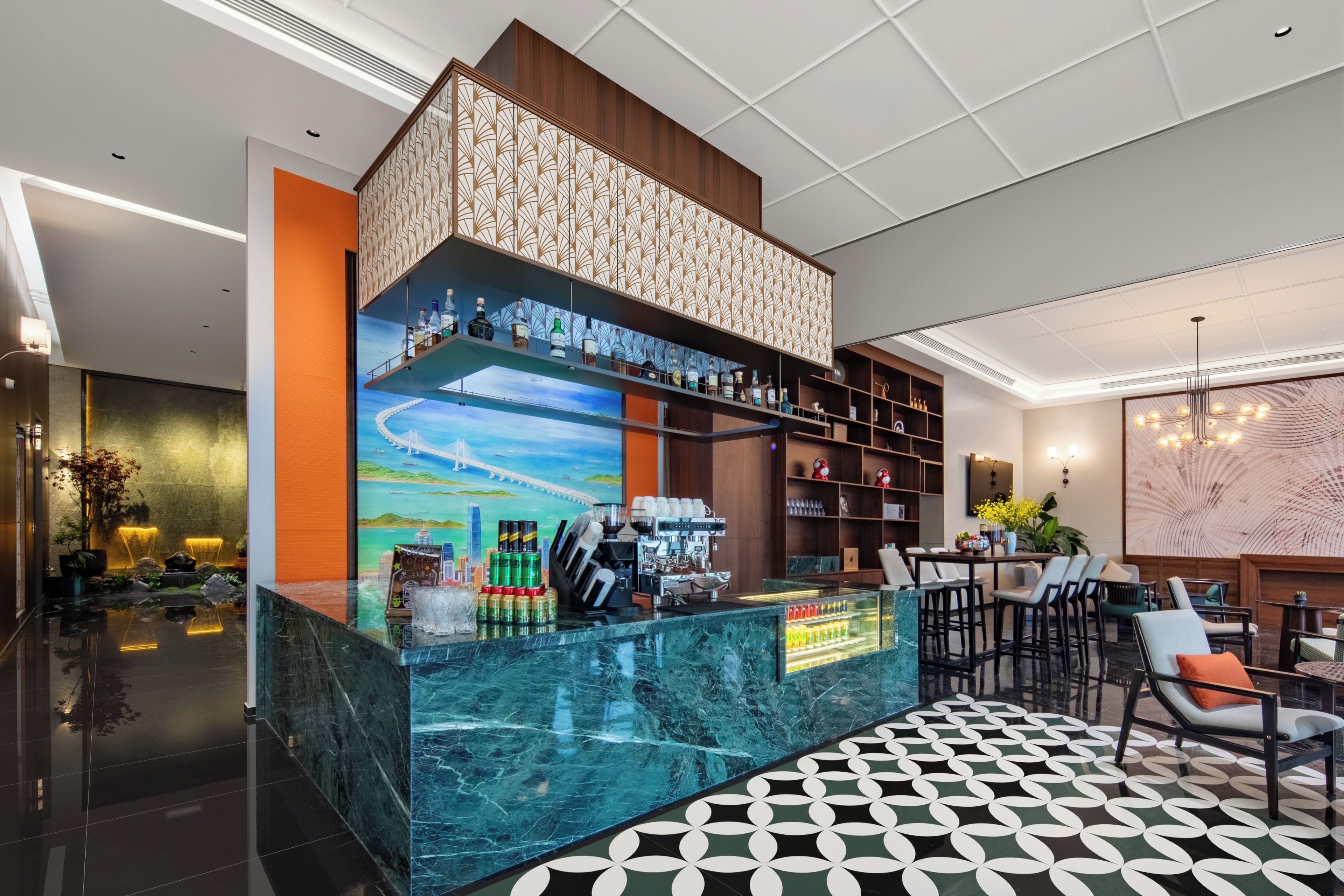 A modern bar area with a marble countertop, shelves with bottles, and a cityscape mural.