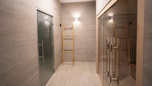 A modern bathroom with a glass shower enclosure, a wooden ladder, and a light fixture on the wall. - Hotel Casamore (Meria)