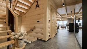 A wooden interior with a staircase, a dining area, and a glass partition. - EcoWood Tatry by Jasek Premium (Poronin)