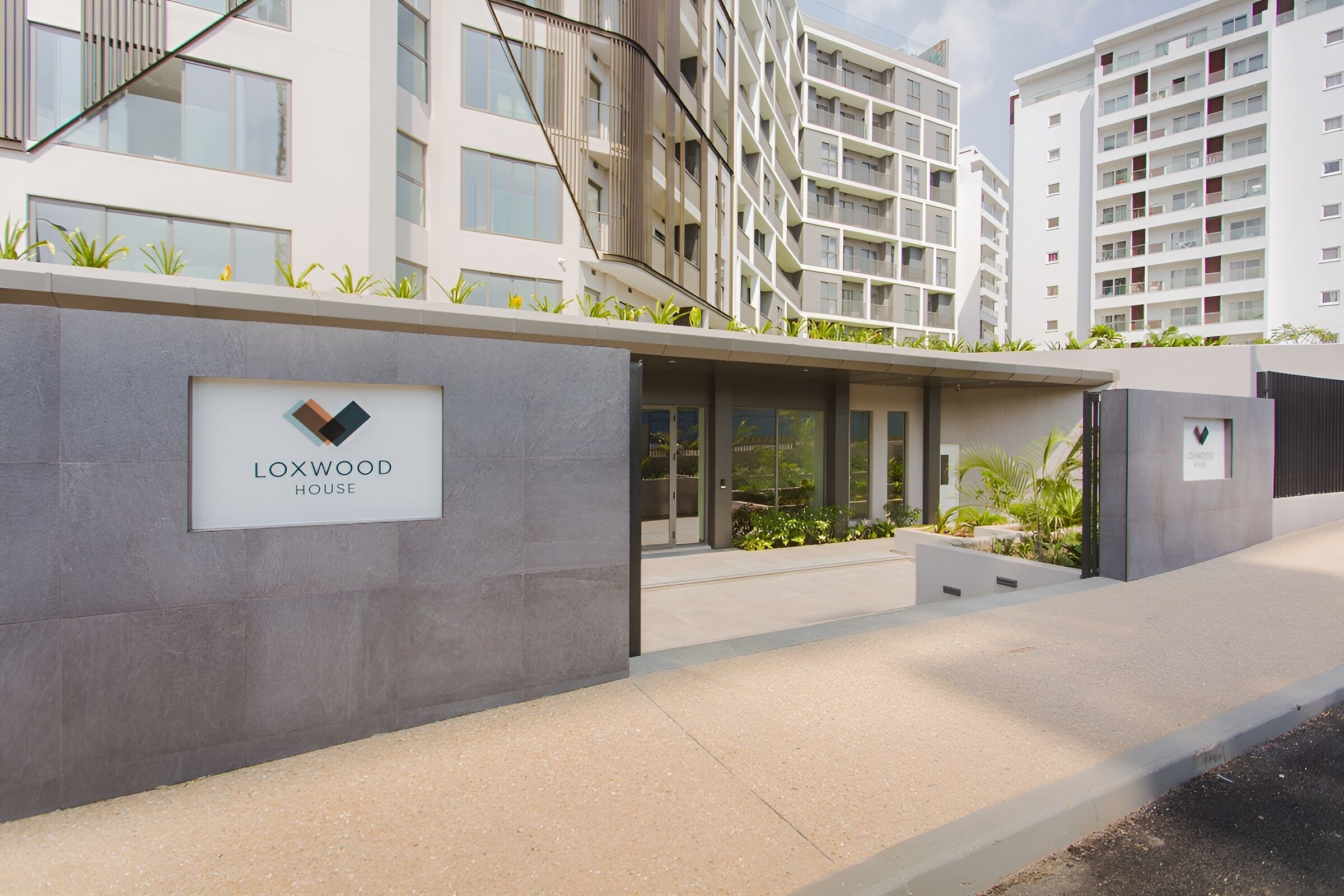 A modern building with a sign reading 'LOXWOOD HOUSE.'