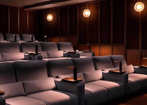 A cinema with rows of plush seating and wall-mounted lighting. - Student Only Non Ensuite Room Ivy Halls (London)