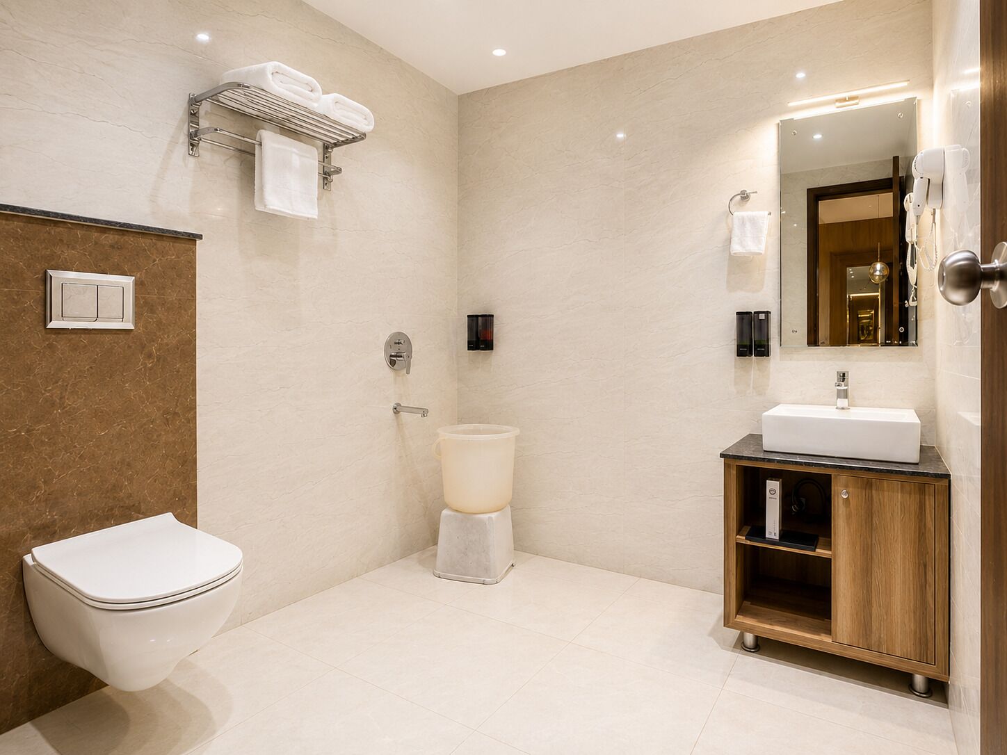 A modern bathroom with a toilet, bidet, vanity with a sink, and a mirror.